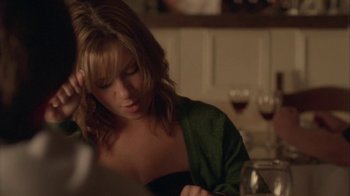 Movie still from “Boy A” (2007), directed by John Crowley – A woman sitting at a table with a glass of red wine; Close Up shot, Over the shoulder angle