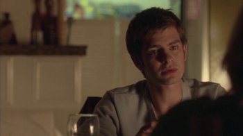 Movie still from “Boy A” (2007), directed by John Crowley – A man sitting at a table with a glass of wine; Close Up shot, Over the shoulder angle