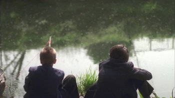 Movie still from “Boy A” (2007), directed by John Crowley – Three children sitting on a bench looking out at a pond; Wide shot, High angle