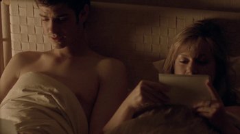 Movie still from “Boy A” (2007), directed by John Crowley – A man and a woman in bed reading a book; Medium shot, Over the shoulder angle