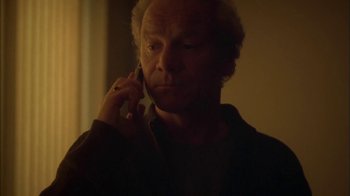 Movie still from “Boy A” (2007), directed by John Crowley – An older man talking on a cell phone in a dark room; Close Up shot, Low angle