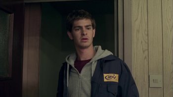 Movie still from “Boy A” (2007), directed by John Crowley – A man in a gray shirt and a blue jacket; Close Up shot, Low angle