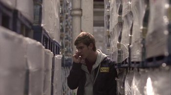 Movie still from “Boy A” (2007), directed by John Crowley – A young man is talking on a cell phone; Medium shot, Low angle