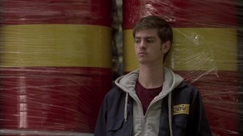 Movie still from “Boy A” (2007), directed by John Crowley – A young man standing next to a red and yellow wall; Close Up shot, Low angle
