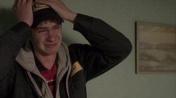 Movie still from “Boy A” (2007), directed by John Crowley – A young man wearing a hat and jacket; Close Up shot, High angle