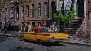 Movie still from “Breakfast at Tiffany's” (1961), directed by Blake Edwards – An old car parked on the side of the street; Wide shot, Low angle
