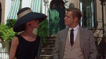 Movie still from “Breakfast at Tiffany's” (1961), directed by Blake Edwards – A man and a woman standing next to each other; Medium shot, Over the shoulder angle