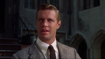 Movie still from “Breakfast at Tiffany's” (1961), directed by Blake Edwards – A person wearing a suit and a tie; Close Up shot, Low angle