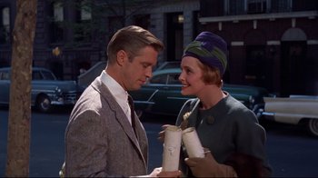 Movie still from “Breakfast at Tiffany's” (1961), directed by Blake Edwards – A man and a woman standing next to each other on the street; Medium shot, Low angle
