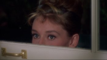 Movie still from “Breakfast at Tiffany's” (1961), directed by Blake Edwards – A woman's eyes looking into a mirror; Close Up shot, Over the shoulder angle