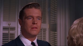 Movie still from “Breakfast at Tiffany's” (1961), directed by Blake Edwards – A person wearing a suit and tie; Close Up shot, Low angle