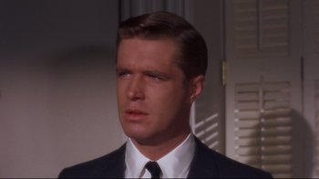 Movie still from “Breakfast at Tiffany's” (1961), directed by Blake Edwards – A person wearing a suit and a tie; Close Up shot, Over the shoulder angle