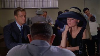 Movie still from “Breakfast at Tiffany's” (1961), directed by Blake Edwards – A group of people sitting around a table; Medium shot, Over the shoulder angle