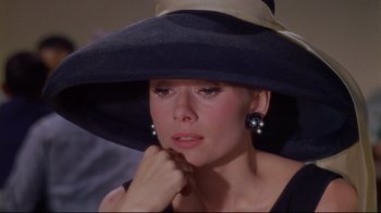 Movie still from “Breakfast at Tiffany's” (1961), directed by Blake Edwards – A person wearing a hat; Close Up shot, High angle