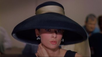 Movie still from “Breakfast at Tiffany's” (1961), directed by Blake Edwards – A person wearing a hat; Close Up shot, Over the shoulder angle