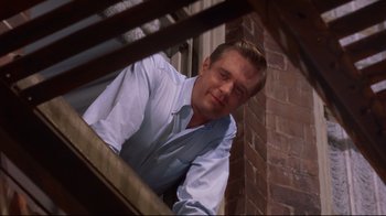Movie still from “Breakfast at Tiffany's” (1961), directed by Blake Edwards – A person leaning on a railing; Medium shot, Low angle