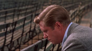 Movie still from “Breakfast at Tiffany's” (1961), directed by Blake Edwards – A person wearing a suit and tie; Close Up shot, Over the shoulder angle