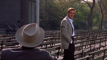 Movie still from “Breakfast at Tiffany's” (1961), directed by Blake Edwards – A man standing in front of another man wearing a cowboy hat; Medium shot, Over the shoulder angle