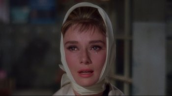 Movie still from “Breakfast at Tiffany's” (1961), directed by Blake Edwards – A person wearing a head scarf; Close Up shot, Over the shoulder angle