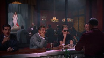 Movie still from “Breakfast at Tiffany's” (1961), directed by Blake Edwards – A man and a woman sitting at a table in a bar; Wide shot, Over the shoulder angle