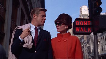 Movie still from “Breakfast at Tiffany's” (1961), directed by Blake Edwards – A man and a woman standing next to each other on the street; Medium shot, Low angle