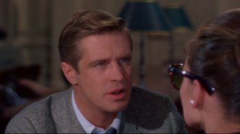 Movie still from “Breakfast at Tiffany's” (1961), directed by Blake Edwards – A person wearing a suit and tie; Close Up shot, Over the shoulder angle