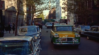 Movie still from “Breakfast at Tiffany's” (1961), directed by Blake Edwards – A street filled with lots of traffic and parked cars; Extreme Wide shot, High angle