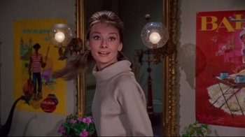 Movie still from “Breakfast at Tiffany's” (1961), directed by Blake Edwards – A woman standing in front of a mirror; Medium shot, Low angle