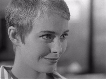 Movie still from “Breathless” (1960), directed by Jean-Luc Godard – A person with short hair; Close Up shot, Over the shoulder angle