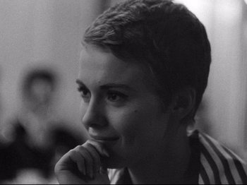 Movie still from “Breathless” (1960), directed by Jean-Luc Godard – Black and white photograph of a woman with short hair; Close Up shot, Over the shoulder angle