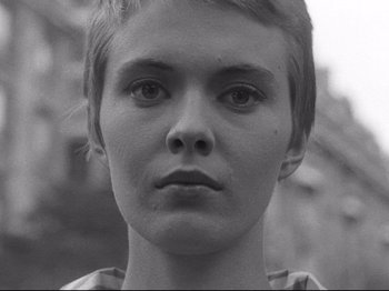 Movie still from “Breathless” (1960), directed by Jean-Luc Godard – A black and white photo of a woman's face; Close Up shot, Low angle
