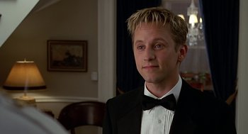 Movie still from “Bride of Chucky” (1998), directed by Ronny Yu – A man wearing a tuxedo and a bow tie; Close Up shot, High angle