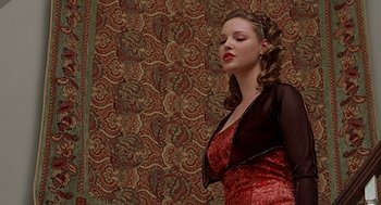 Movie still from “Bride of Chucky” (1998), directed by Ronny Yu – A beautiful young lady wearing a red dress; Medium shot, Low angle