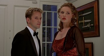 Movie still from “Bride of Chucky” (1998), directed by Ronny Yu – A man and a woman posing for a picture; Close Up shot, Low angle