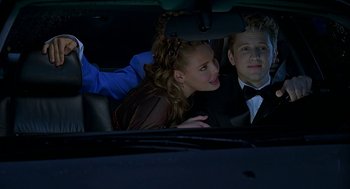 Movie still from “Bride of Chucky” (1998), directed by Ronny Yu – A man and a woman sitting in the back of a car; Medium shot, Over the shoulder angle