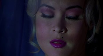 Movie still from “Bride of Chucky” (1998), directed by Ronny Yu – A person with pink lipstick; Extreme Close Up shot, Overhead angle