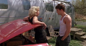 Movie still from “Bride of Chucky” (1998), directed by Ronny Yu – A man and a woman standing in front of an rv; Medium shot, Low angle