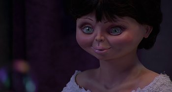 Movie still from “Bride of Chucky” (1998), directed by Ronny Yu – The face of a doll with green eyes; Close Up shot, Low angle