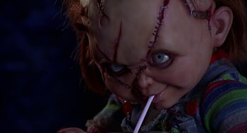 Movie still from “Bride of Chucky” (1998), directed by Ronny Yu – A doll with a knife in its mouth; Close Up shot, Low angle
