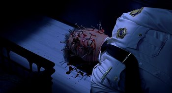 Movie still from “Bride of Chucky” (1998), directed by Ronny Yu – A police officer is laying on a table with a head covered in fake blood; Close Up shot, Overhead angle