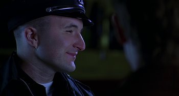 Movie still from “Bride of Chucky” (1998), directed by Ronny Yu – A person wearing a hat; Close Up shot, Low angle