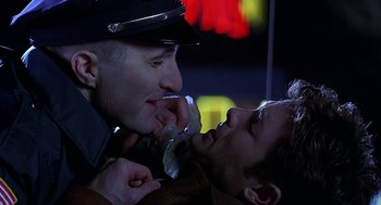 Movie still from “Bride of Chucky” (1998), directed by Ronny Yu – Two men are kissing each other on the lips; Close Up shot, Over the shoulder angle