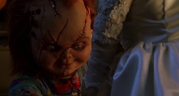 Movie still from “Bride of Chucky” (1998), directed by Ronny Yu – A chucky doll's face; Close Up shot, Overhead angle