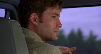 Movie still from “Bride of Chucky” (1998), directed by Ronny Yu – A person sitting in a car; Close Up shot, Over the shoulder angle