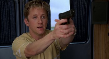 Movie still from “Bride of Chucky” (1998), directed by Ronny Yu – A man holding a gun in his hand; Close Up shot, Low angle