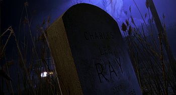 Movie still from “Bride of Chucky” (1998), directed by Ronny Yu – A grave marker with the name of charles lee ray etched on it; Wide shot, Low angle