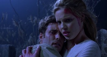 Movie still from “Bride of Chucky” (1998), directed by Ronny Yu – A man and a woman with blood all over their faces; Close Up shot, Low angle