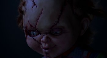 Movie still from “Bride of Chucky” (1998), directed by Ronny Yu – A doll's face with stitches on it's head; Extreme Close Up shot, Low angle