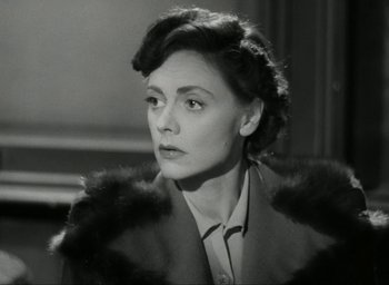 Movie still from “Brief Encounter” (1945), directed by David Lean – An old photo of a woman wearing a fur coat; Close Up shot, Low angle