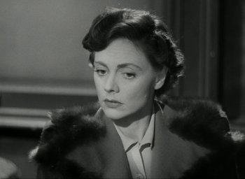 Movie still from “Brief Encounter” (1945), directed by David Lean – An old photo of a woman wearing a fur coat; Close Up shot, High angle
